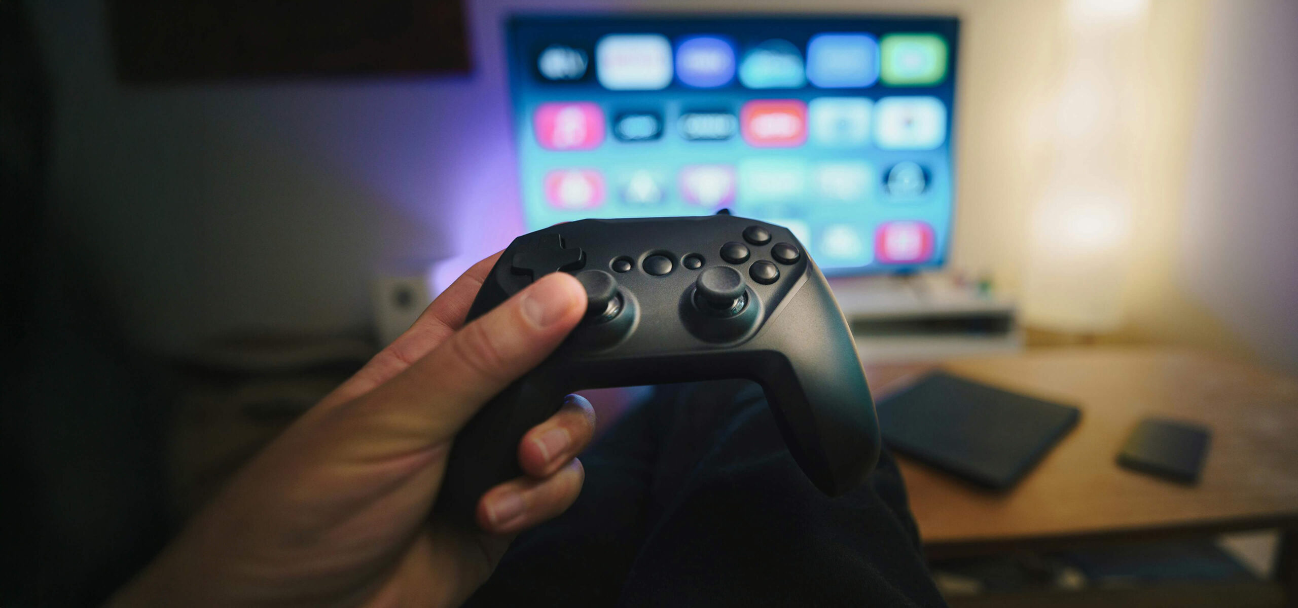 gamer using console controller to navigate smart tv scaled