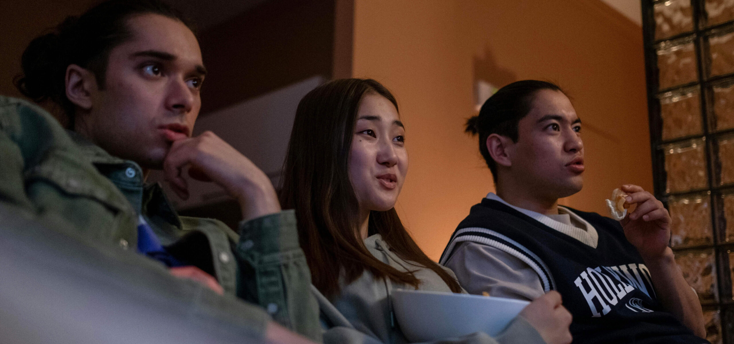 group of friends watching tv from their sofa scaled